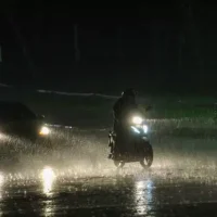 Motociclista se arrisca no meio do temporal em Campo Grande (Foto: Juliano Almeida).