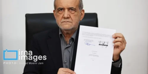 O presidente iraniano, Masoud Pezeshkian, mostrando o memorando de entendimento com os EUA após assiná-lo • Ahmad Moeini Jam/IRNA